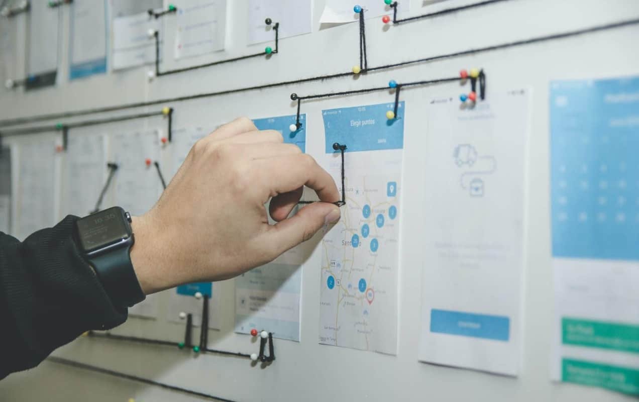 person working on a website layout on a whiteboard